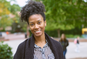 Woman smiling at camera standing on the campus