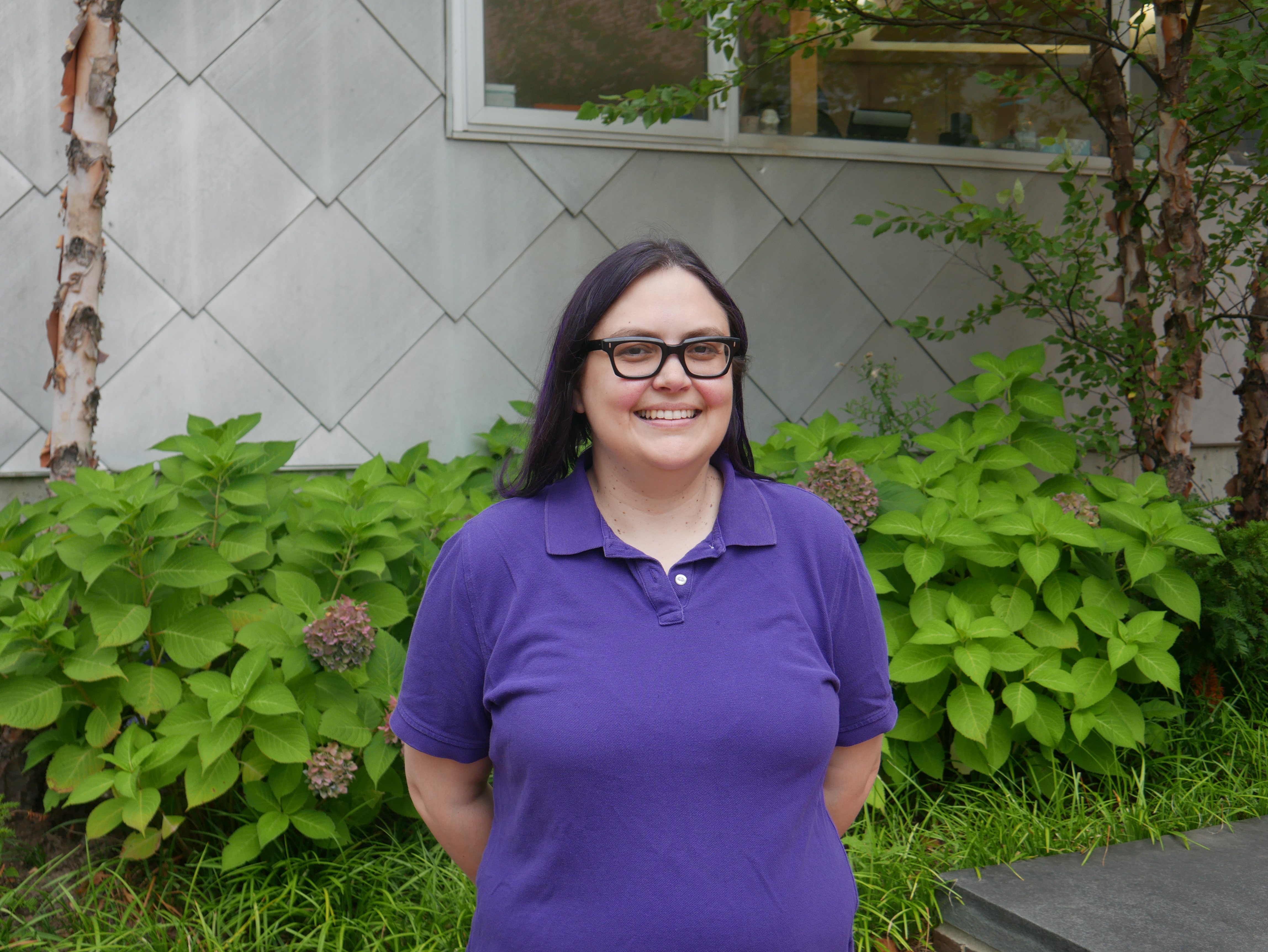 photo of woman smiling outside on campus