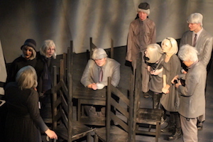 Actors in costume performing a scene from The Adding Machine.