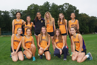 Girls cross country runners gather for a team photo.