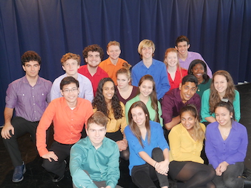 Group of Black, White, Asian, Hispanic and Middle Eastern high school singers posing in brightly colored shirts.