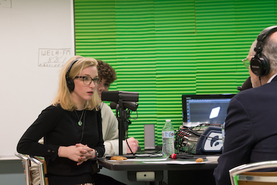 High School student interviews a guest for a radio podcast in a digital production studio.