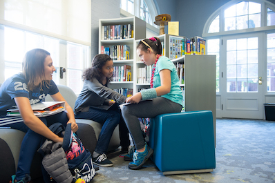 Girls talk in the Middle School Library Learning Commons