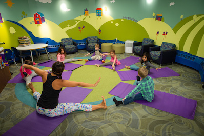 Very young students take a yoga class.