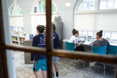 A view through a door into the Middle School Library Learning Commons