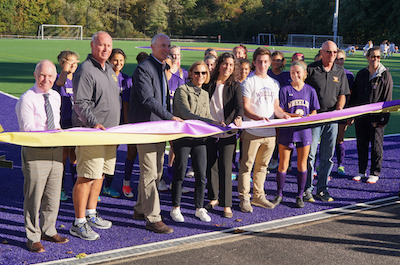 Students, coaches and the donors pose at the ribbon cutting for the Godley Turf Field at the Wheeler Farm.