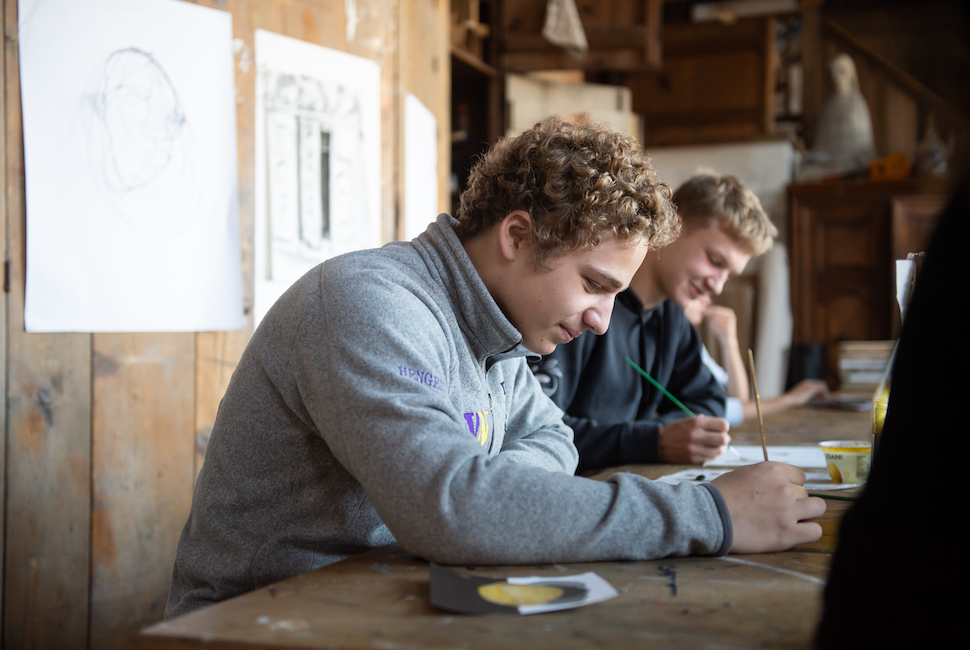 two students work in an art studio.