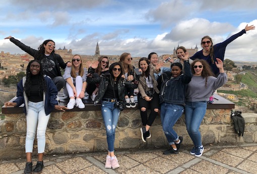 A group of students and teachers gather on a rooftop during a trip to Spain.