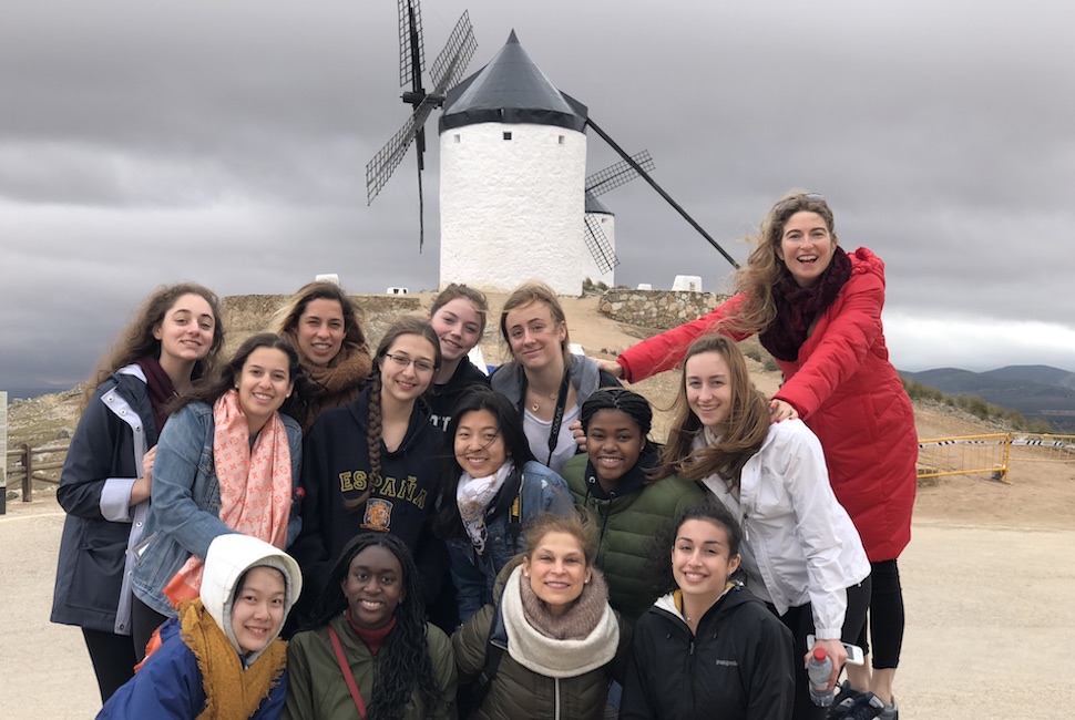 Students and teacher pose in front of a windmill in Consuegra Spain