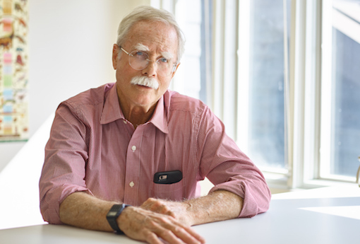 Aerie director Mark Harris sits at a table by a window.