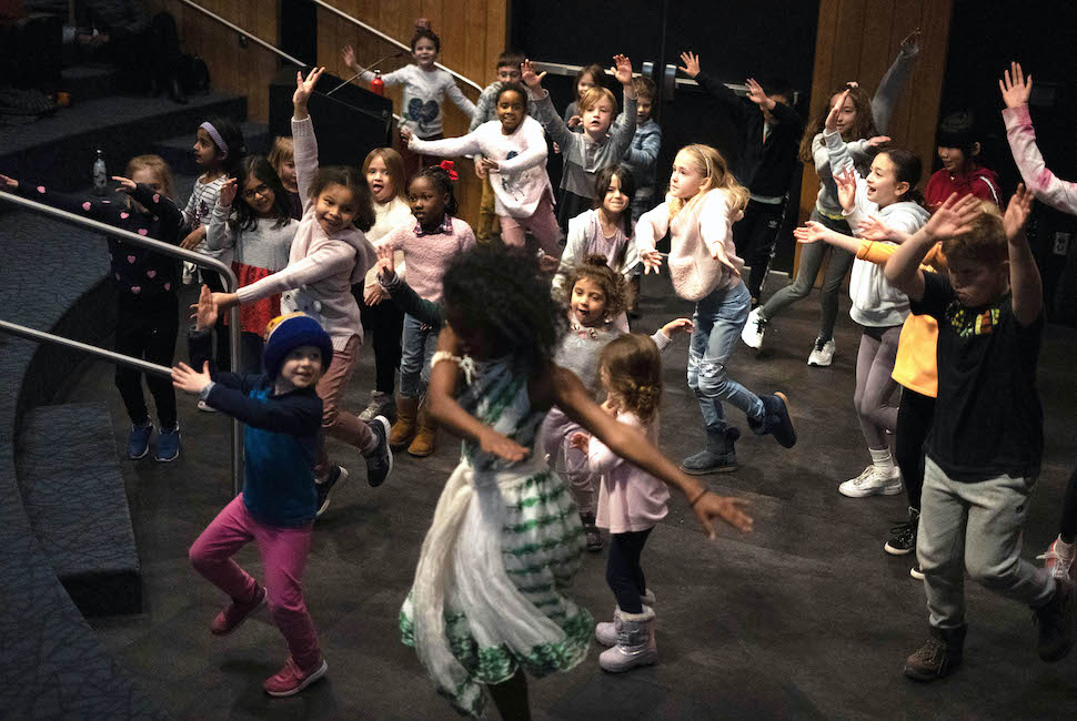 Joyful young children learn an African dance