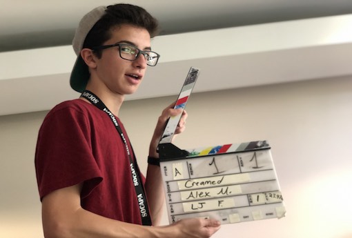 student filmmaker Alex Michaud holding director's slate