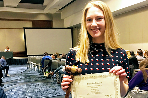 High School student holding certificate for best delegate at Model UN