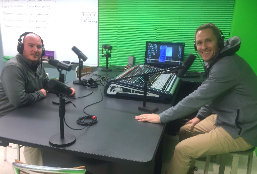 Athletic Trainer Nate Withington and incoming Athletic Director Sean Kelly sit in a radio station on campus.