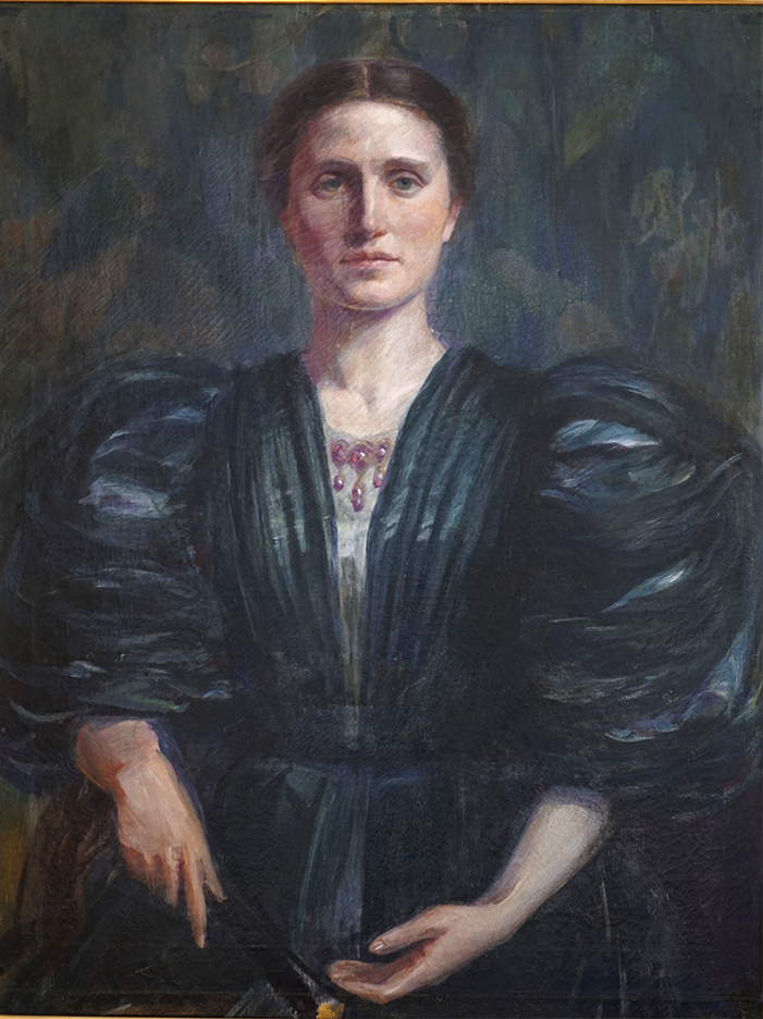Portrait of a young woman in a green dress.