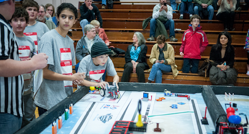 Middle School girls and boys compete in a robotics competion.