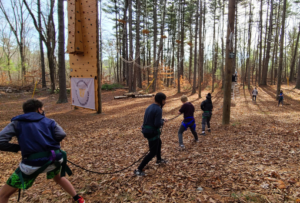 Line of students holding a rope for a swing