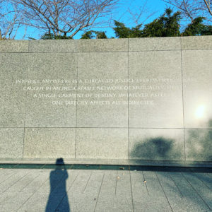 Photo of Head of School's shadow standing at the Martin Luther King Jr. Memorial in DC in 2020.