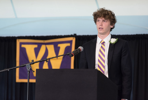 man speaking at podium