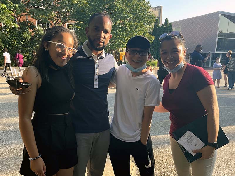 A group photo of Jayleen, Henry, Manny and Emna. They are standing next to one another and smiling at the camera.