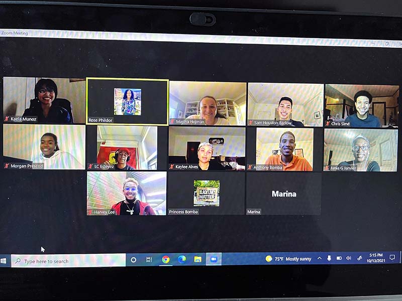 A photograph of a computer screen showing a virtual meeting with alumni mentors and Wheeler staff meeting via Zoom.
