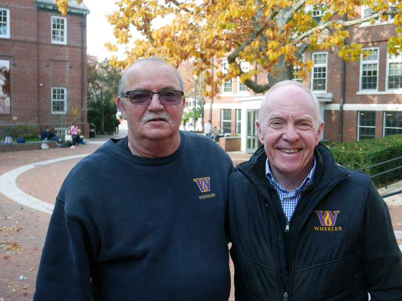 Jerry Delsignore and Gary Esposito stand next to other outside on the Wheeler campus while smiling at the camera.