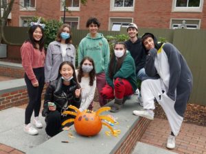 Students pose with their decorated pumpkin.