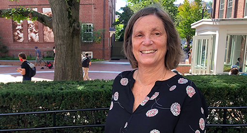 A photo of Head of Upper School Neeltje Henneman standing outside and smiling at the camera.