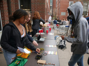 Students look at items like bracelets that were offered at the Girls Empowerment Club's recent fundraiser.