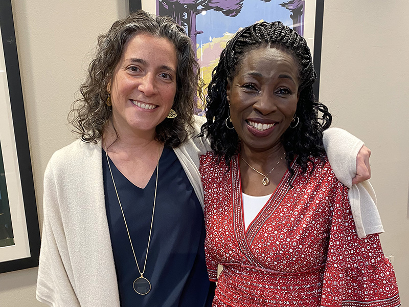 Director of Unity & Diversity Princess Sirleaf Bomba stands next to Head of School Allison Gaines Pell. Allison has her arm around Princess and both people are smiling at the camera.