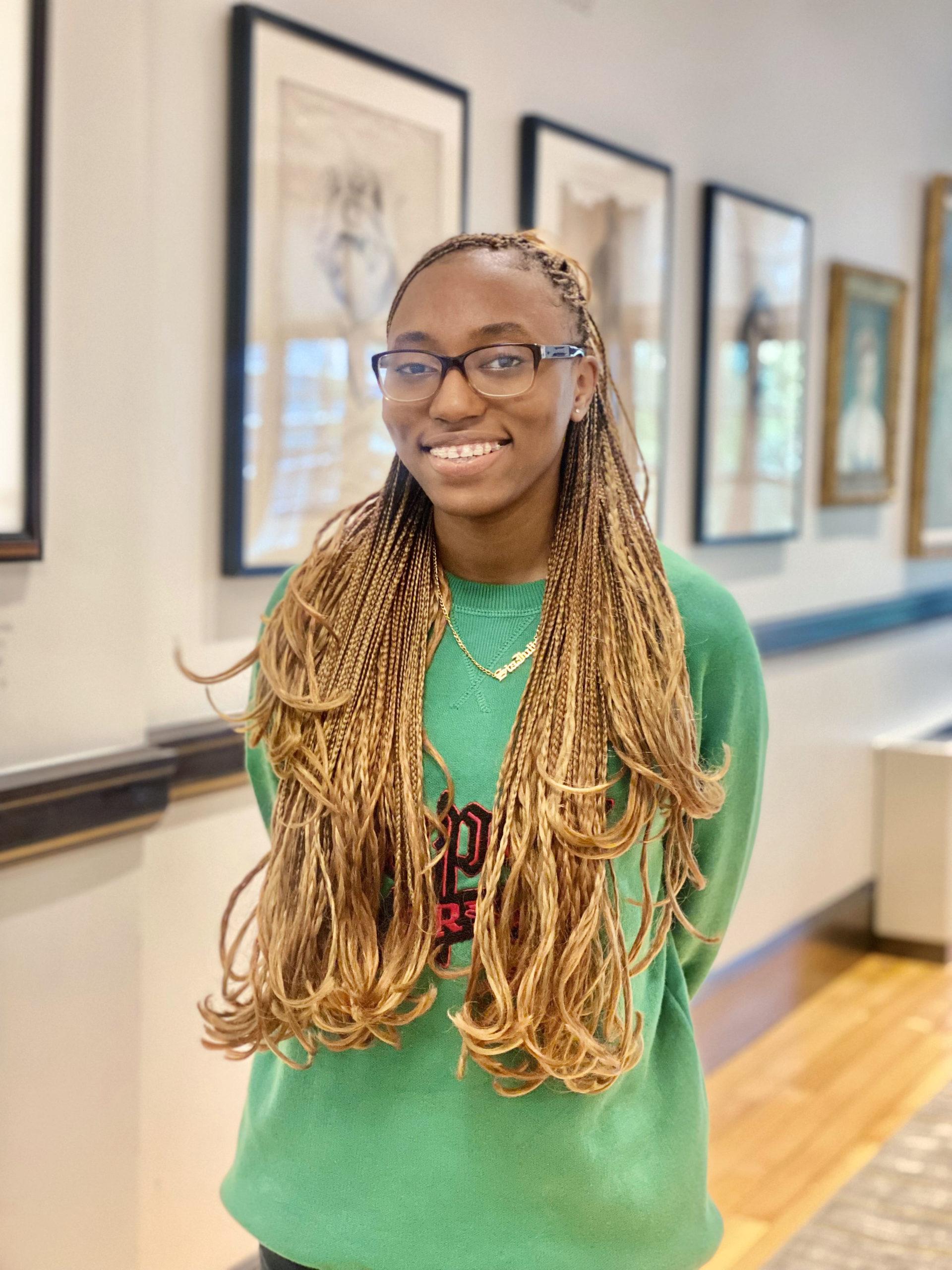 Leenah G. ’23 poses for a photo while standing in the Cummings Room inside Wheeler School's Providence campus.