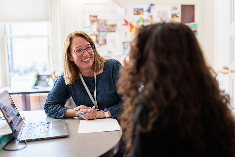 A photo of Director of College Counseling Amy Baumgartel Singer ’89, P’20, P’24 meeting with a student in her office.