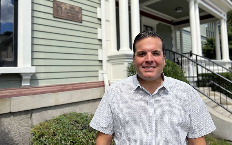 Photo of Head of the Hamilton School at Wheeler Bill McCarthy standing outside of the Hamilton School and smiling at the camera.