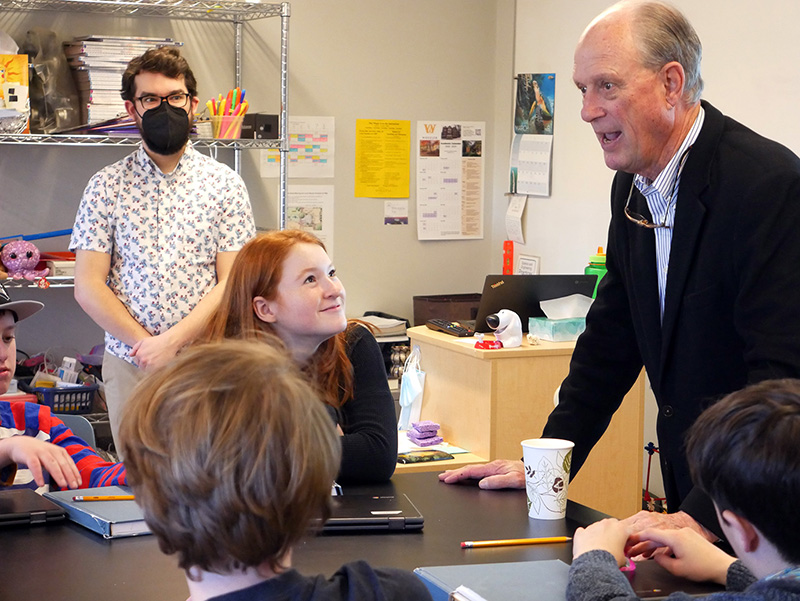 Dr. Ballard talks with Hamilton students in their science classroom.