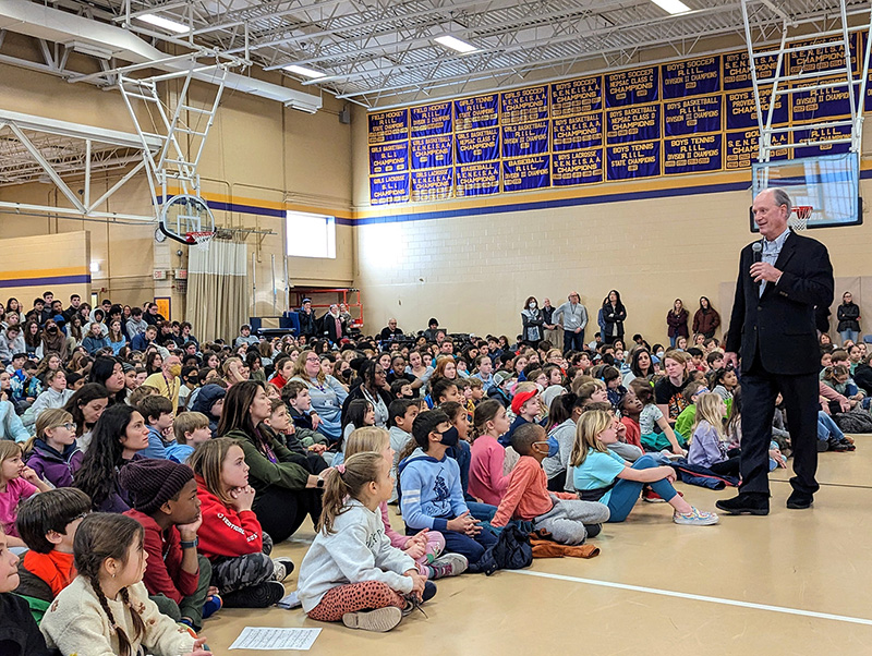Dr. Ballard speaks to a full Madden Gym during the all-school assembly.