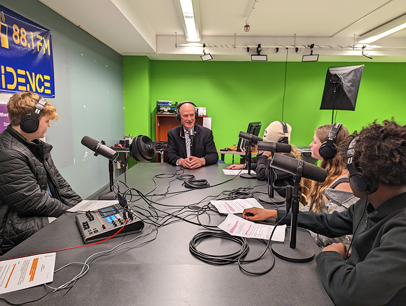 Dr. Ballard records a podcast episode with Hamilton students.
