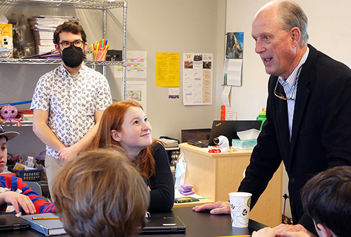 Dr. Ballard talks with Hamilton students in science class.