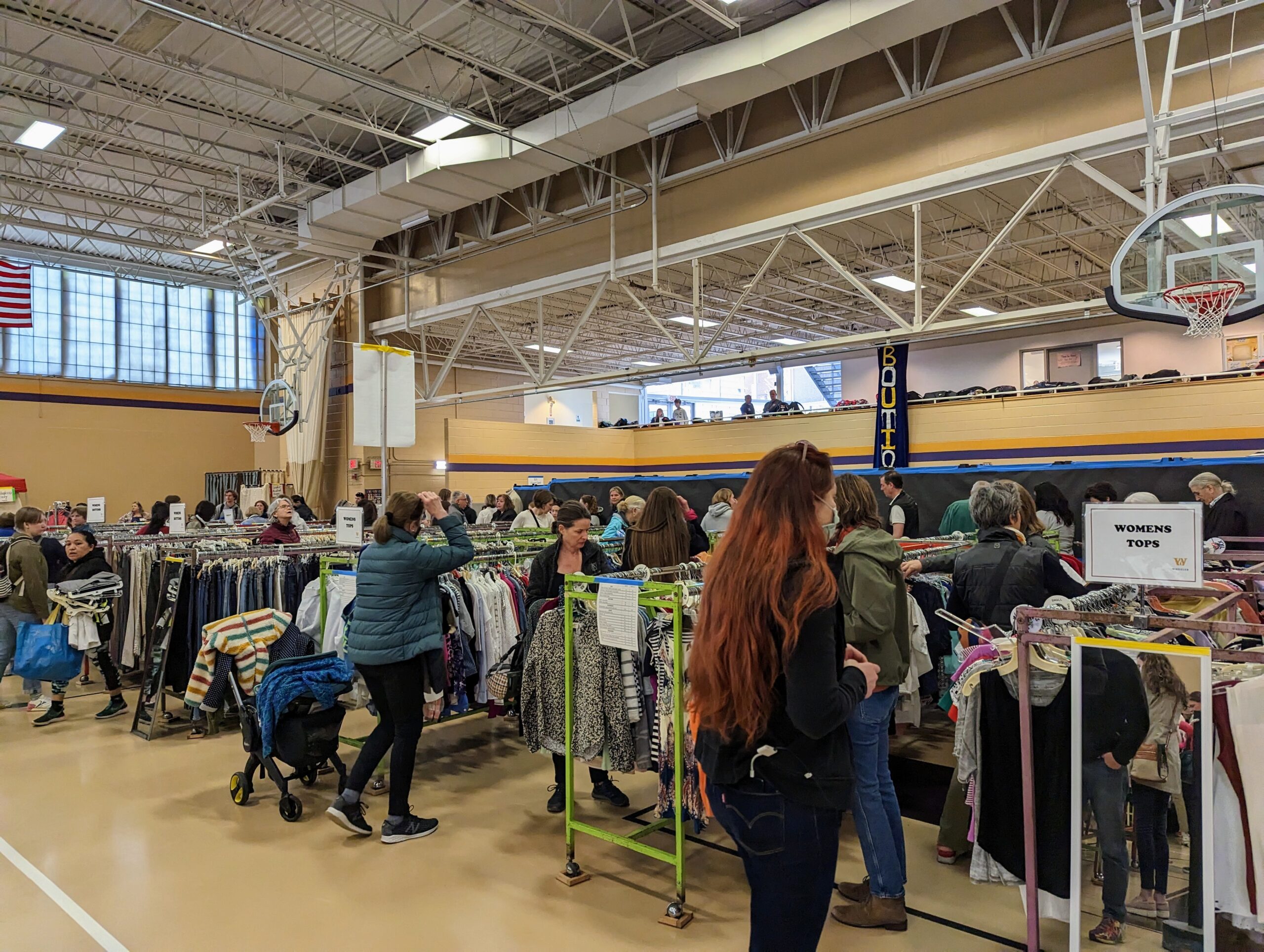 Shoppers looking at the racks of clothes on Opening Day of The Famous Wheeler Clothing Sale. 