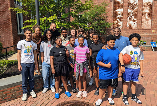 A group photo of Breakthrough Providence Coordinator Eddy Davis '99 with several students and teachers on Wheeler's Providence campus}