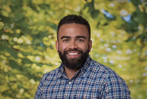 A picture of Josh Cabrera outside and smiling for the camera.