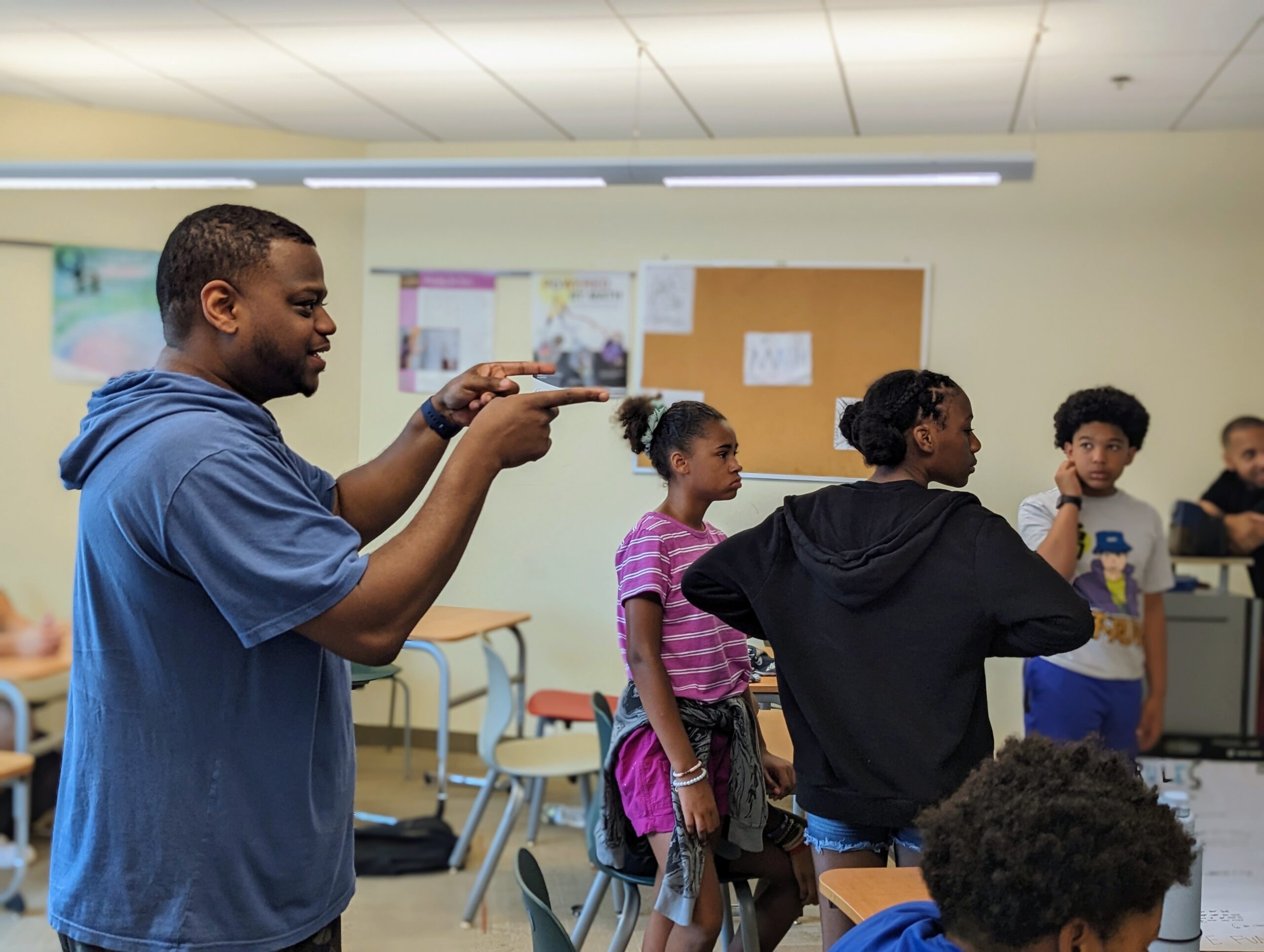 Mr. Davis engaging with a group of students during a class.