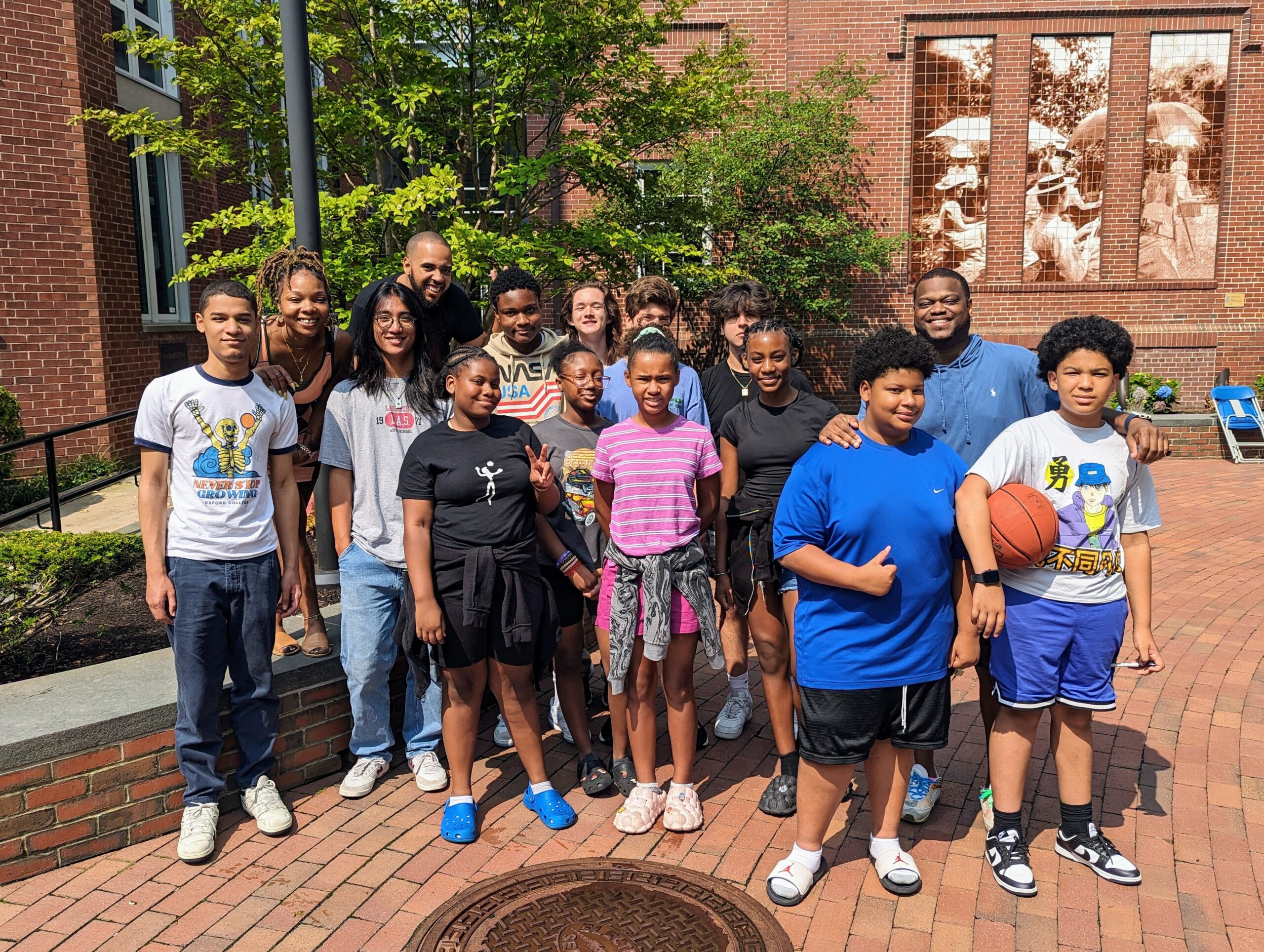 A group photo of Breakthrough Providence Coordinator Eddy Davis '99 (second from the right) with several students and teachers on Wheeler's Providence campus.