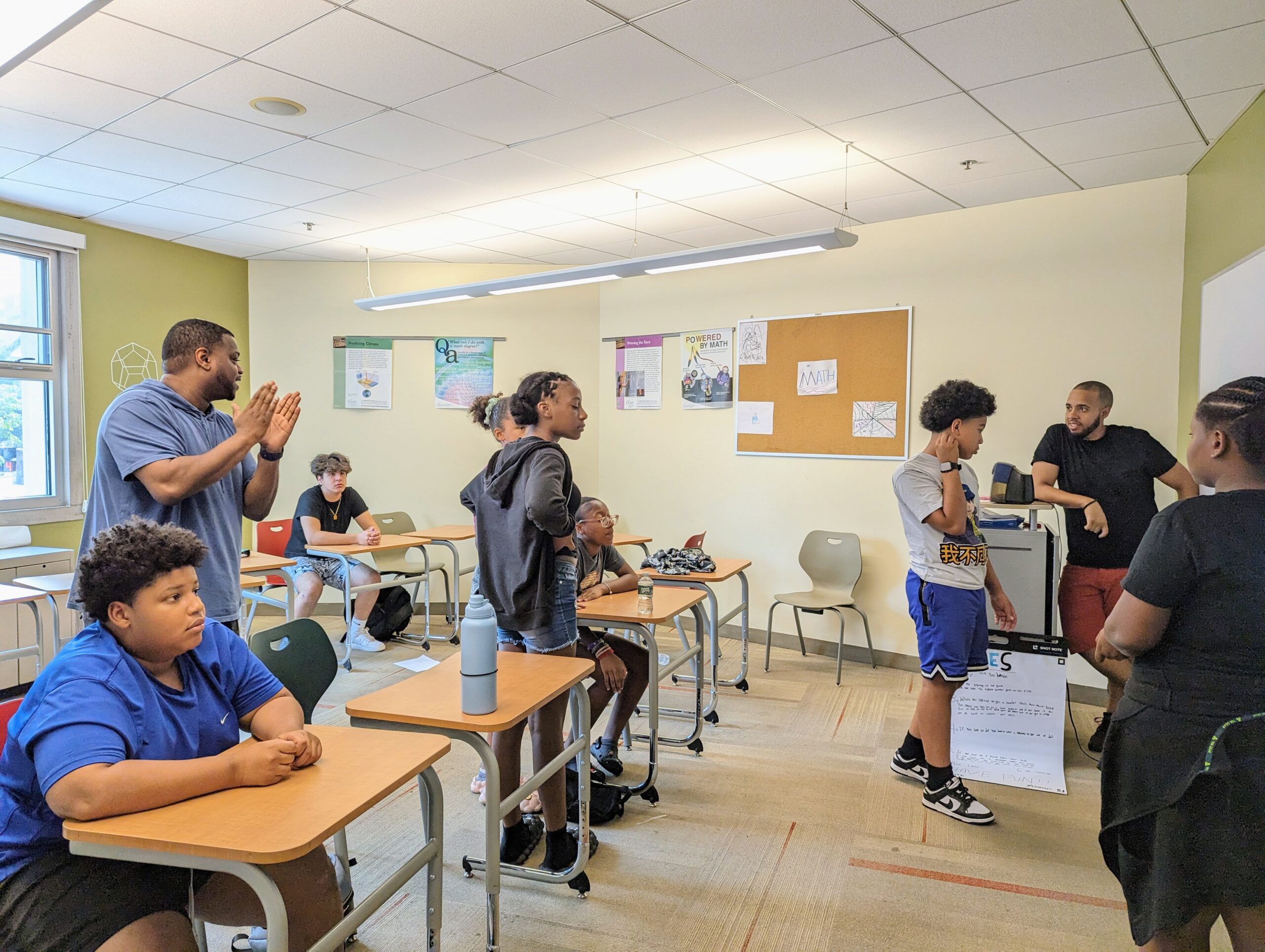 Photo of Mr. Davis engaging with a group of students in a classroom.