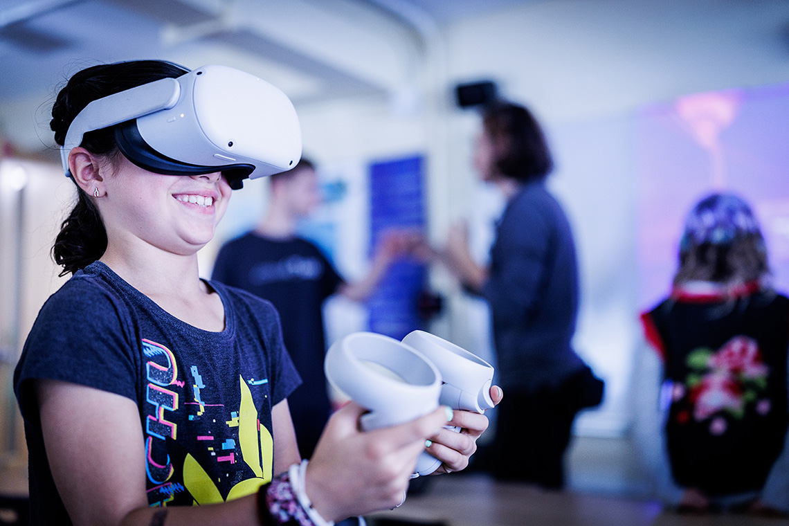 Student interacting with virtual reality equipment in the Wheeler School's XR Lab.