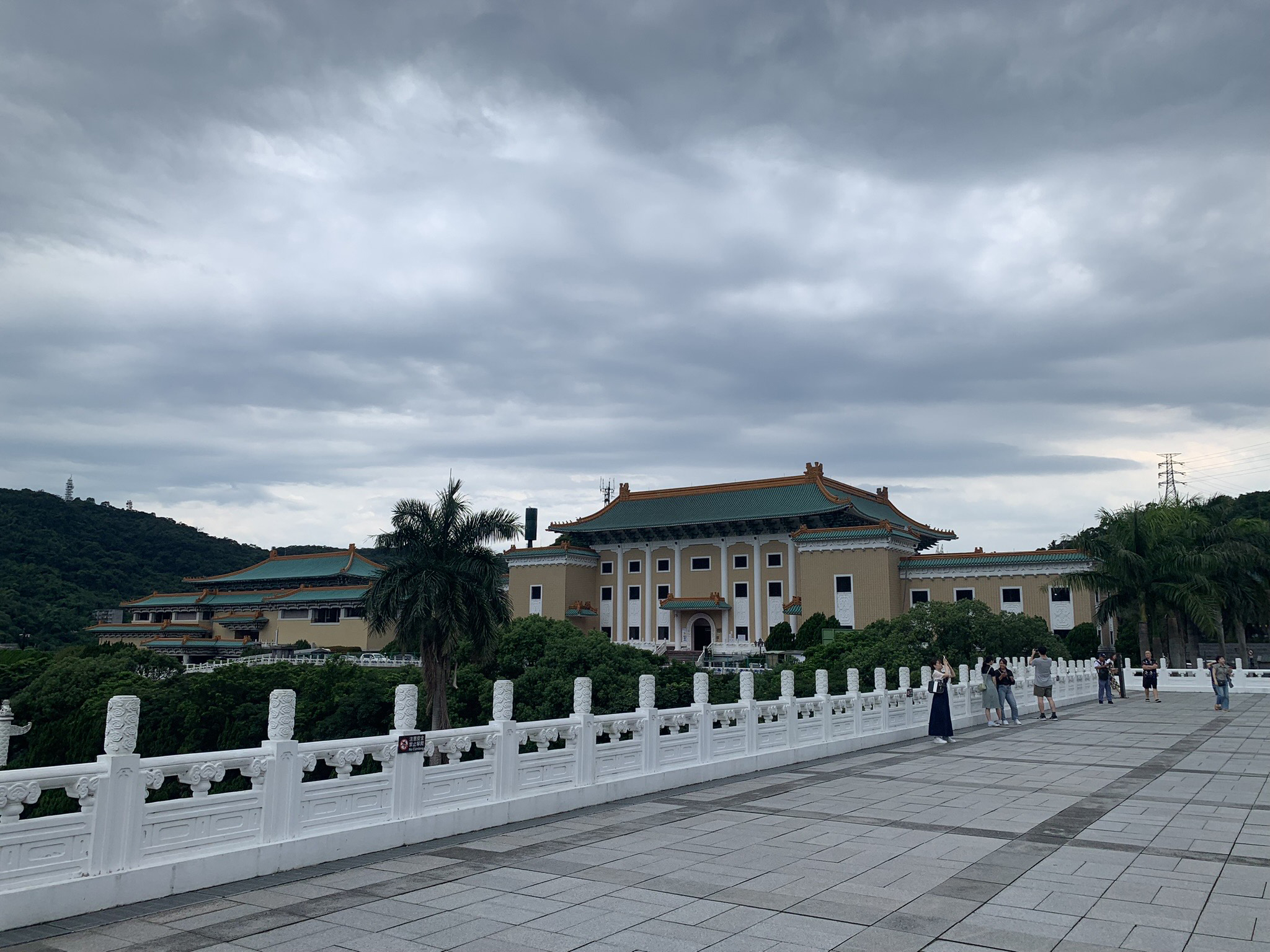 A view of the National Palace Museum in Taipei, Taiwan, with visitors walking nearby. 