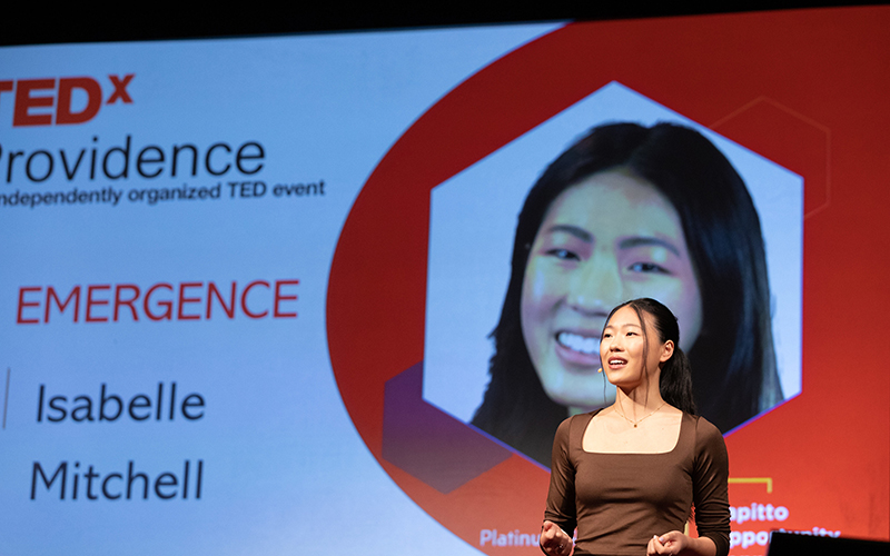 Photo of Wheeler student Isabelle M. '24 presenting on the TedX Providence stage. 