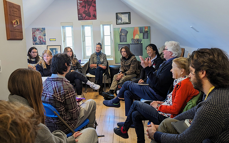 Photo of acclaimed poet, novelist, and artist Wang Ping with Wheeler's Aerie Literary Voices students, Aerie Writer-in-Residence Robert Koppel, including a few faculty and staff members, engaging in the writing workshop in the Aerie Literary Voices space. 