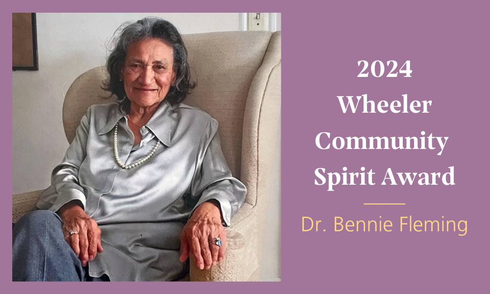 A graphic with a purple background, an image of Dr. Bennie Fleming seated in a chair on the left, and on the right, white and yellow text that reads: "2024 Wheeler Community Spirit Award | Dr. Bennie Fleming"