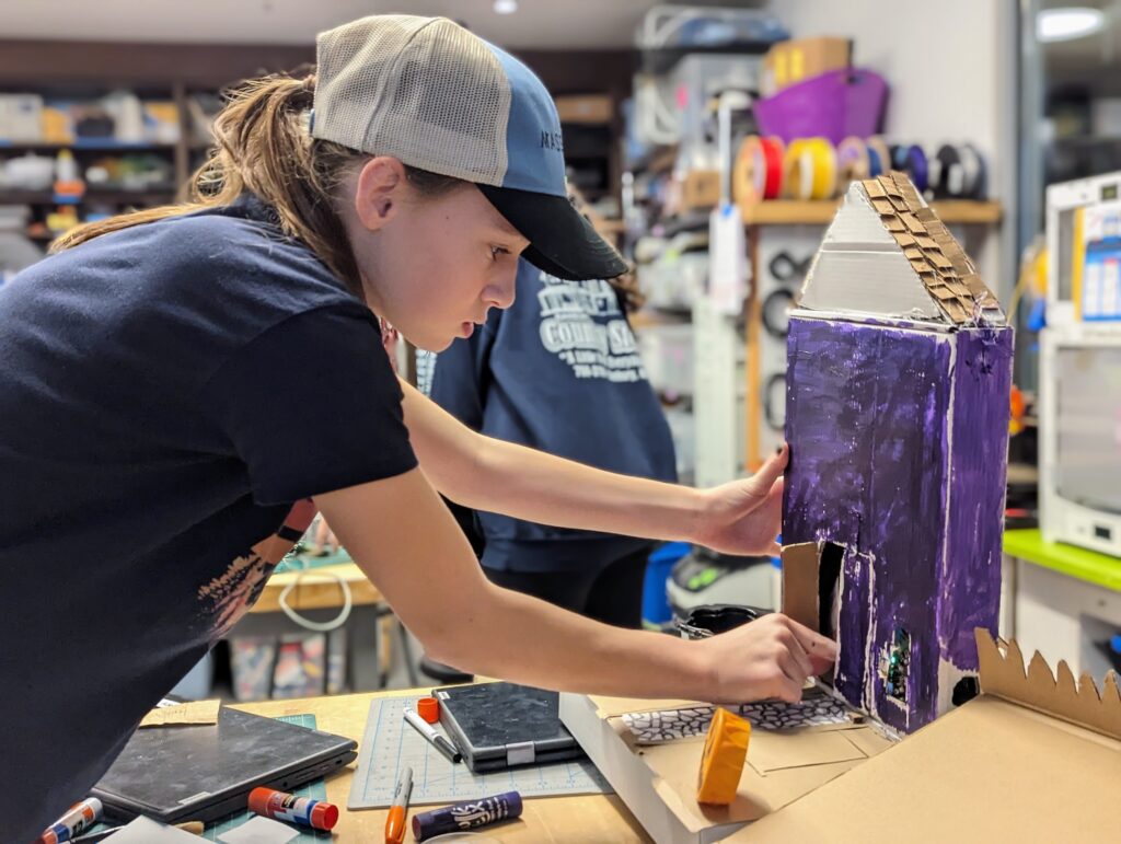 A Wheeler student working on their animatronic Halloween decoration in the DIB Lab. 