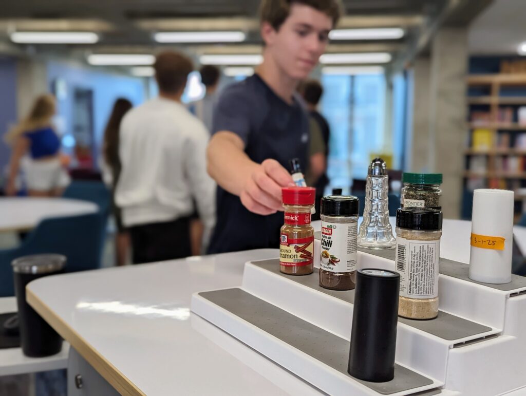 Students participating in an exercise on manual citations with various spices in the library.